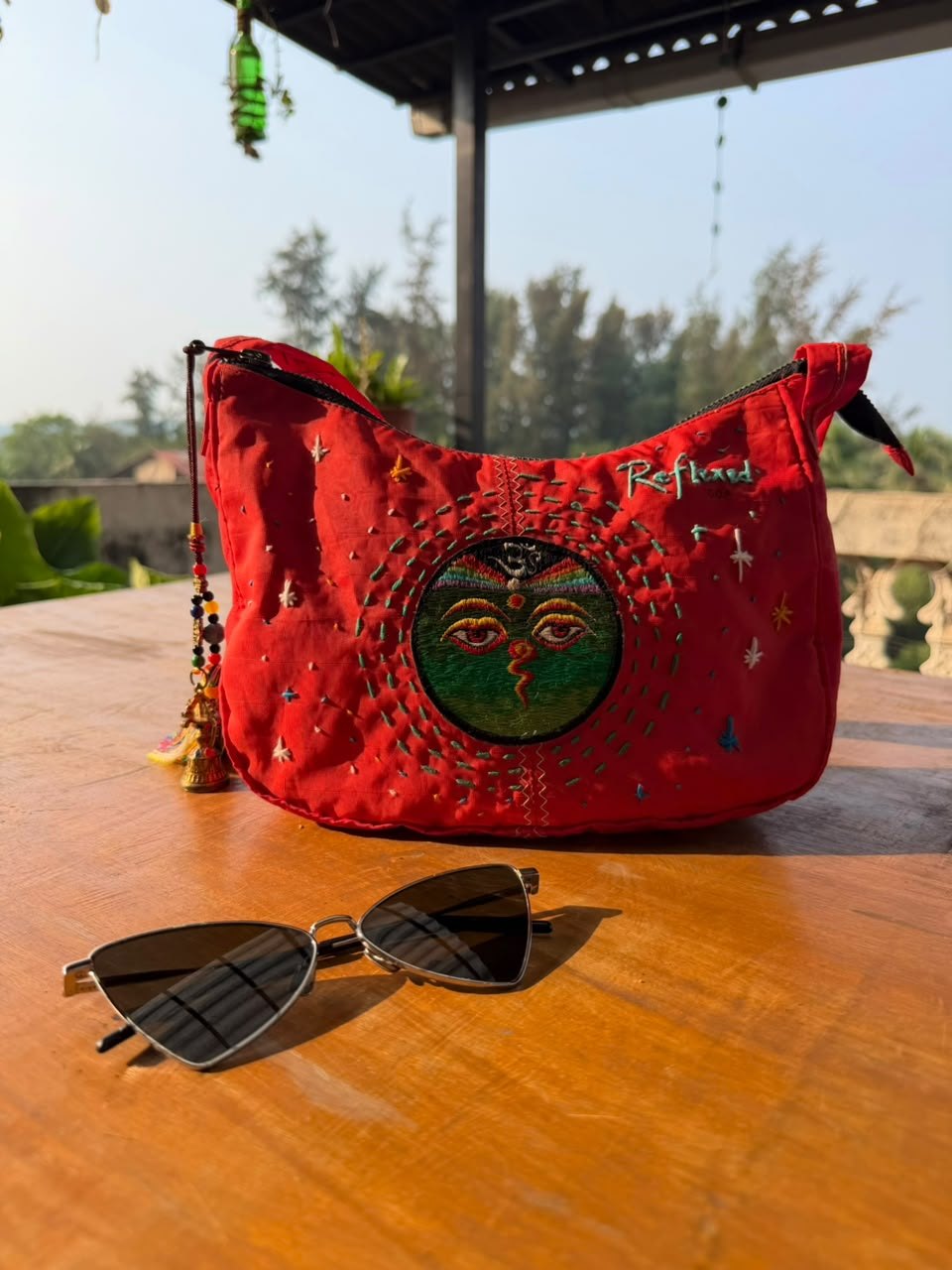 Red shoulder bag made from a retired kitesurf sail