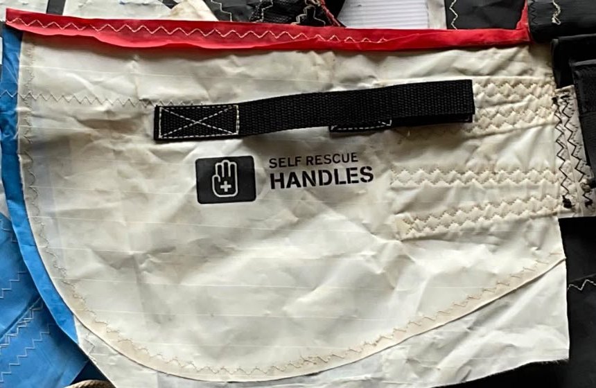 A panel of the original kite showing its printed label and reinforced stitching
